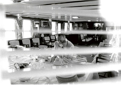 President Lyndon Baines Johnson hard at work seated at the buffet in the main salon.